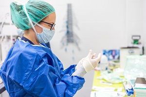 Nurse putting on PPE