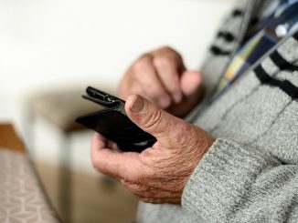 older person holding mobile phone