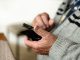 older person holding mobile phone